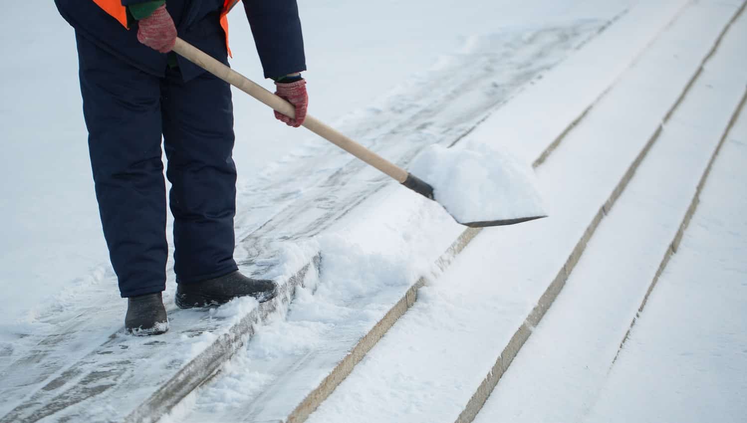 Workers sweep snow from road in winter, Cleaning road from snow storm.