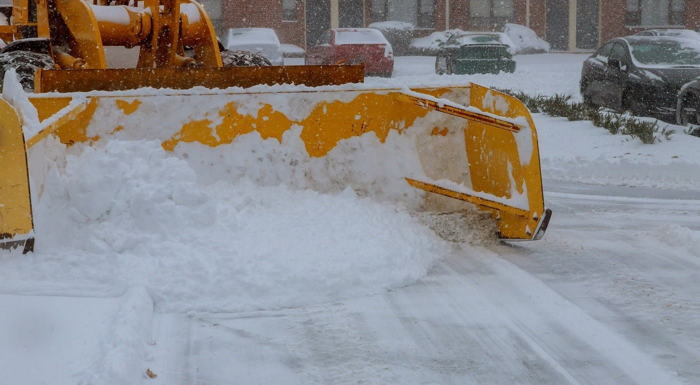 Winter storm snow cleaning machine . Tractor clears the way after heavy snowfall.