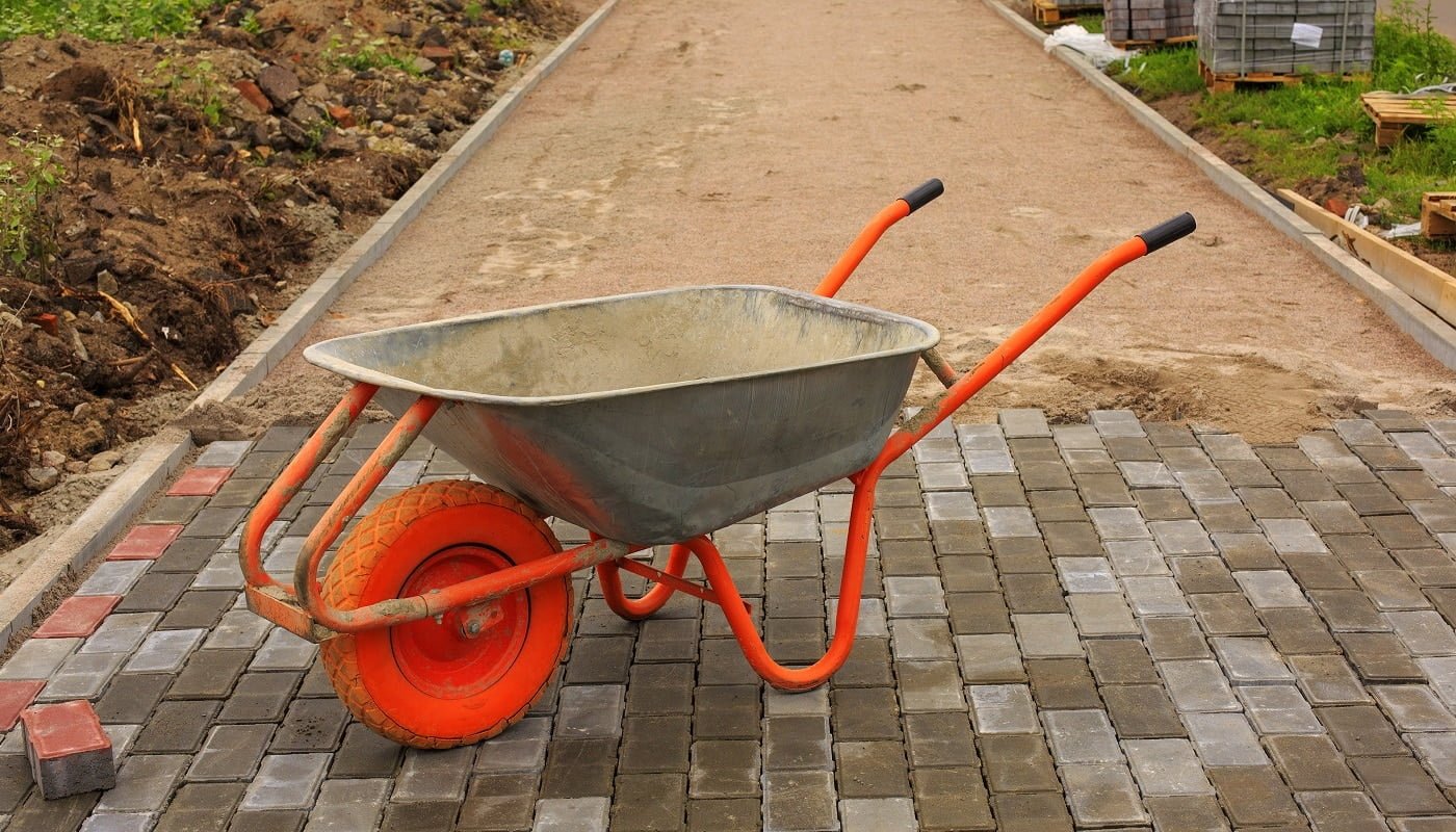 Laying of paving slabs. Repairing sidewalk. Tile in a wheelbarrow.