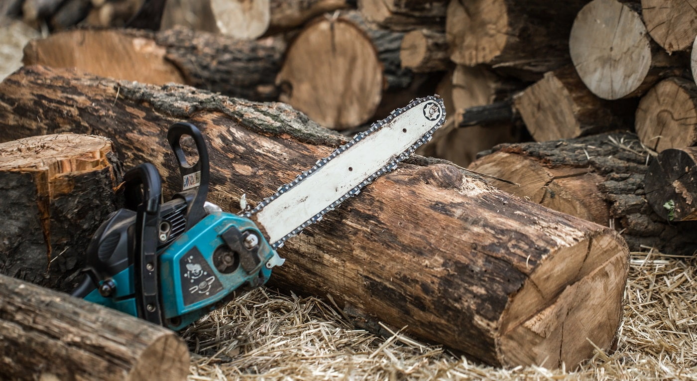 Man chopping wood with a chainsaw ,close-up