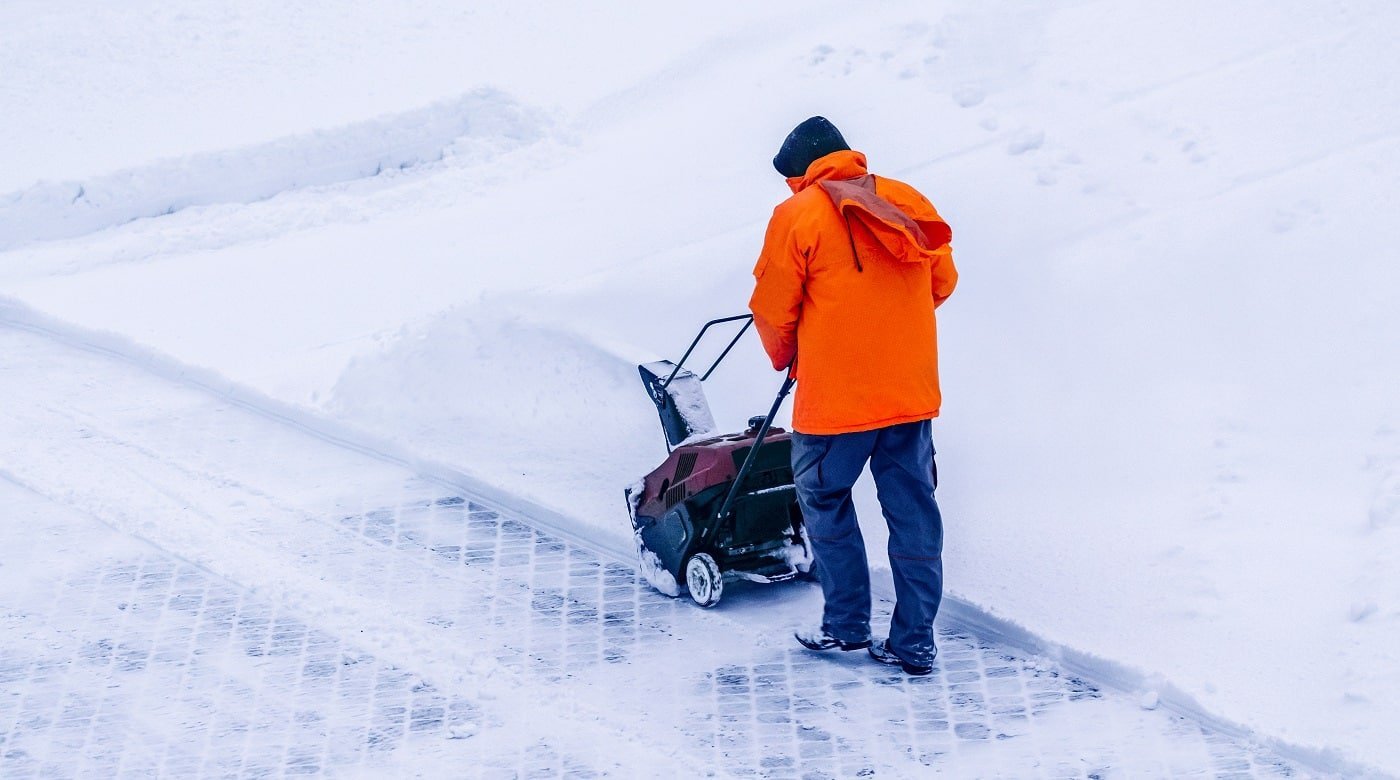 Man with Best Ariens Snow Blowers clears snow
