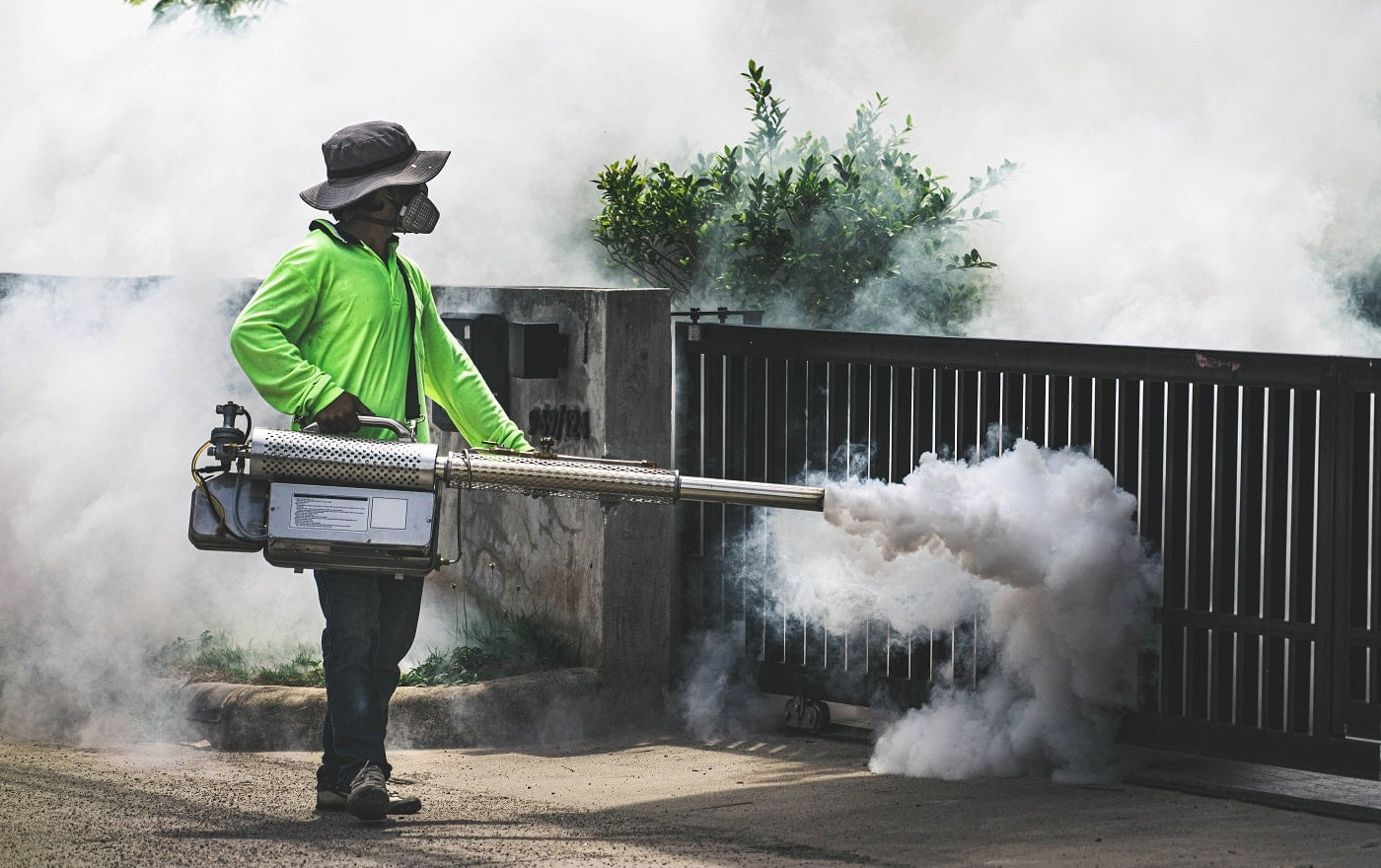 Man using fogger machine to control dangerous from mosquitoes