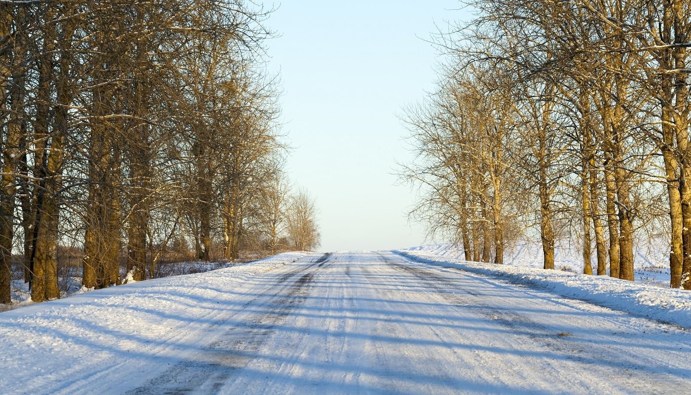 small road covered with snow in the winter season, Photo close-up with a shallow depth of field