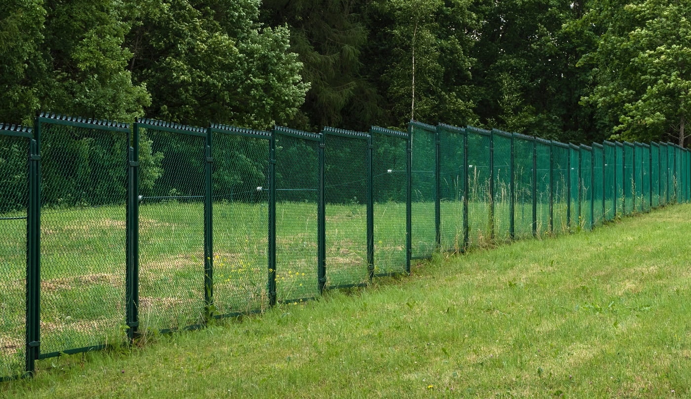 Fences with current on a green field.