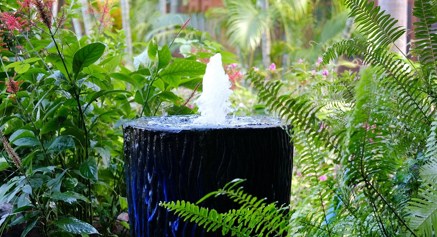 fountain on big blue water jar decorating in garden