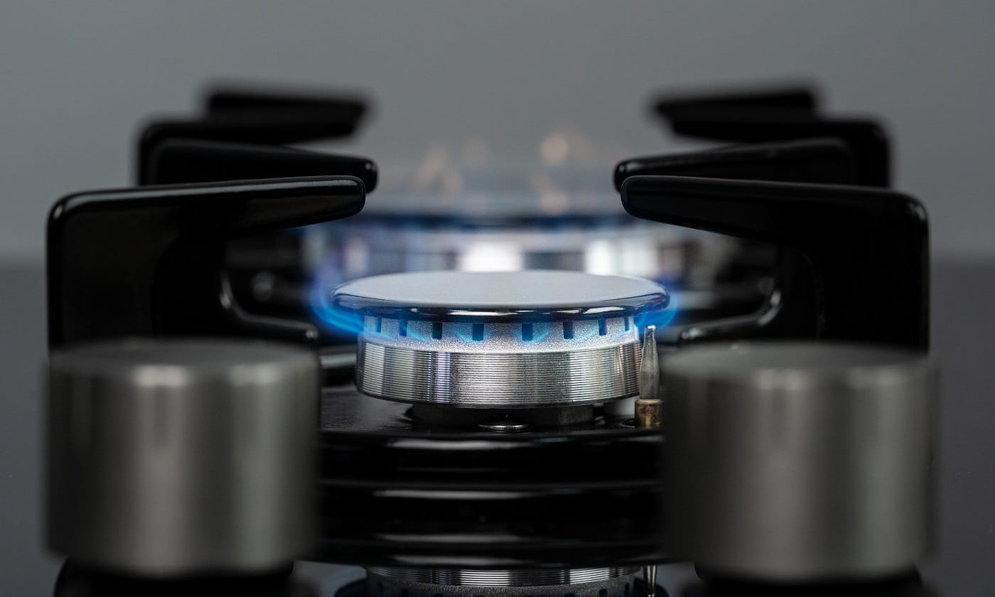 Burning gas stove burner in a kitchen close up