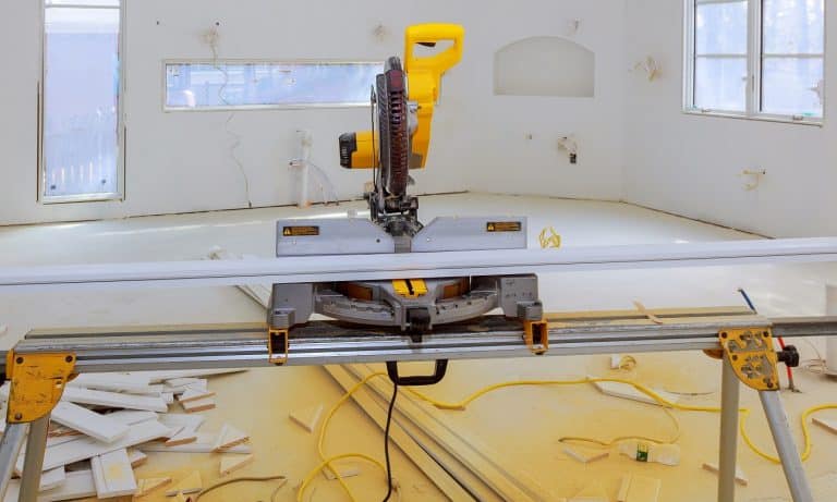 Contractor uses a circular saw to cut trim molding saw on a construction site