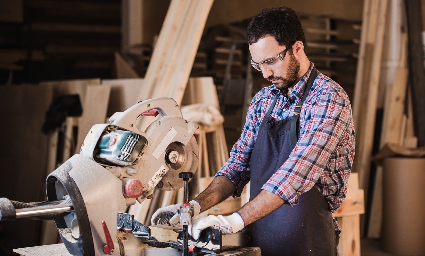 Framing contractor using a circular cut off saw to trim wood studs to length