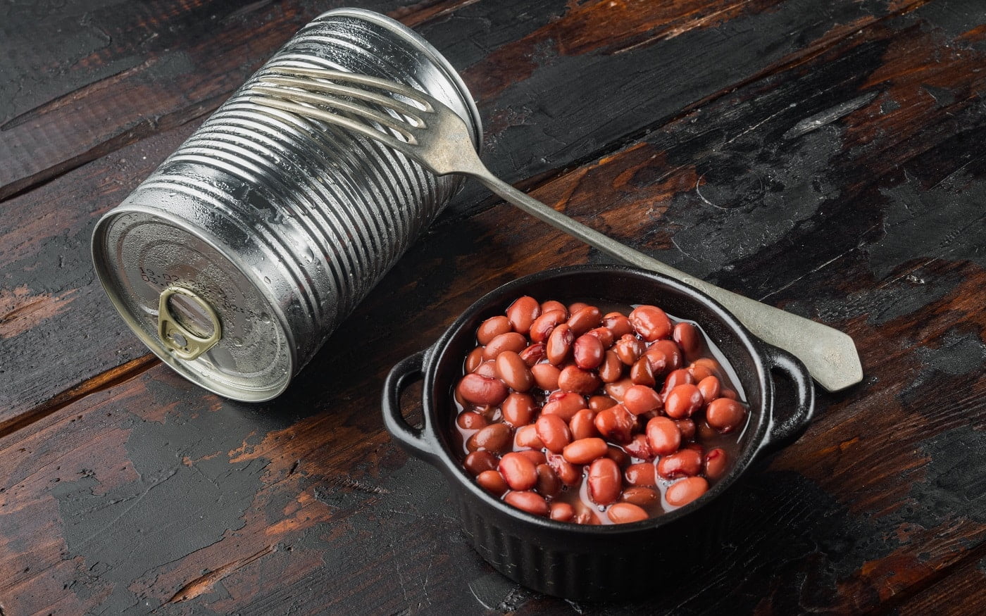 Japanese canned food ingredient, sweet red beans, on old dark wooden table background