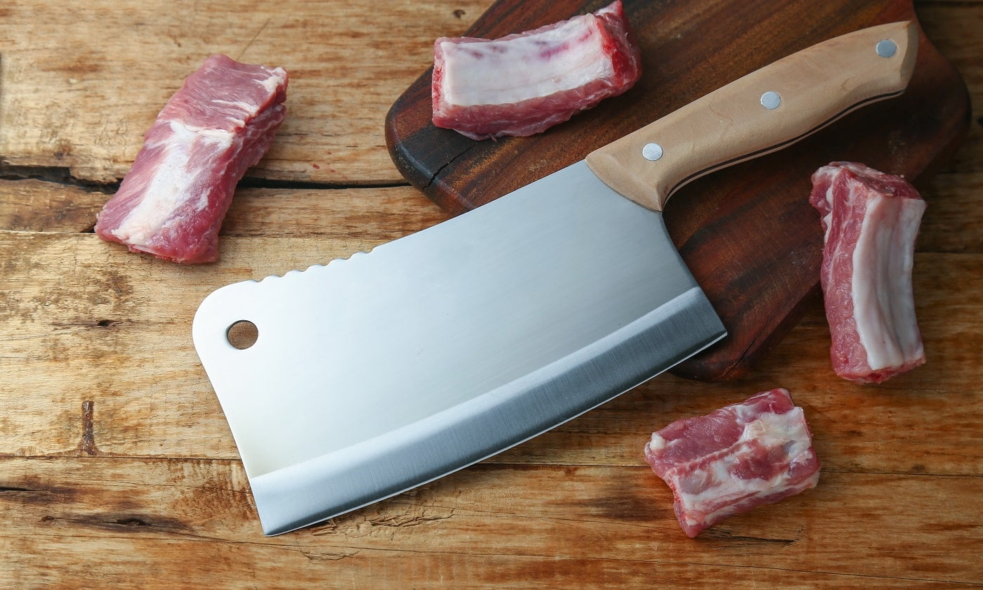 cleaver knife and ribs on wooden board