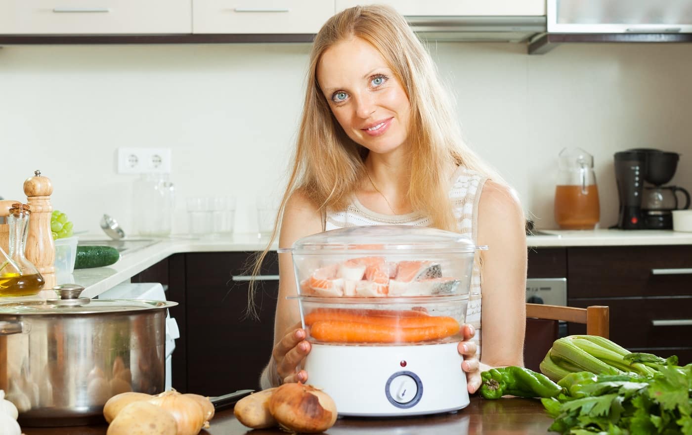 Smiling young woman using Best Tamale Steamer at home kitchen