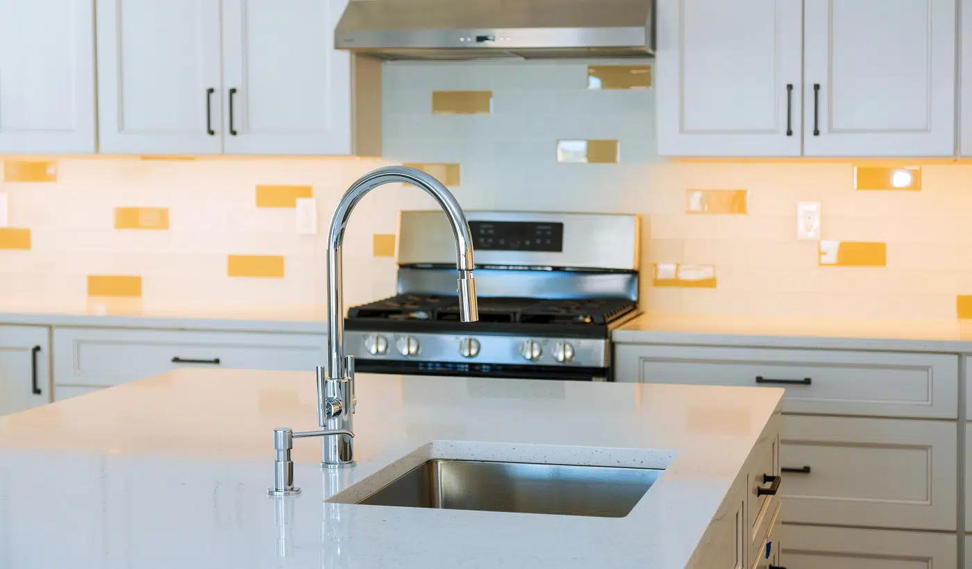 Interior design bright modern kitchen with island sink in the stainless steel appliances