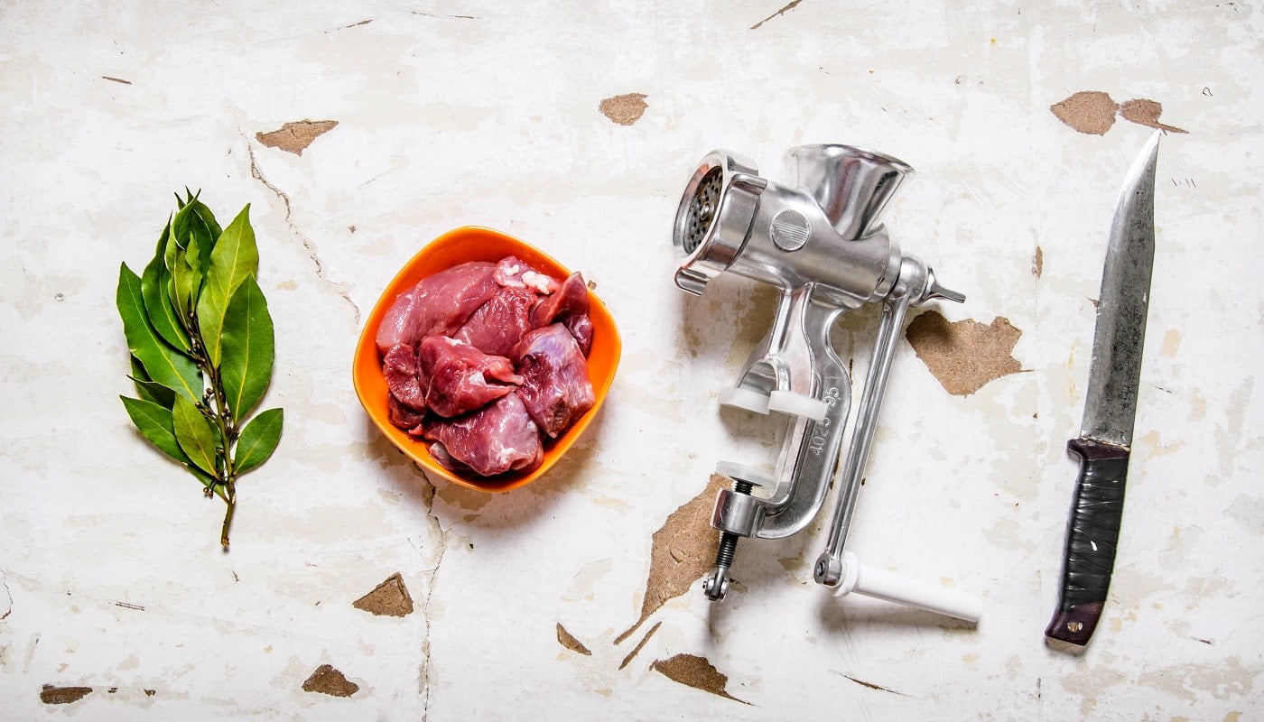 Set - grinder, raw meat, carving knife, Bay leaf. On rustic background. Top view