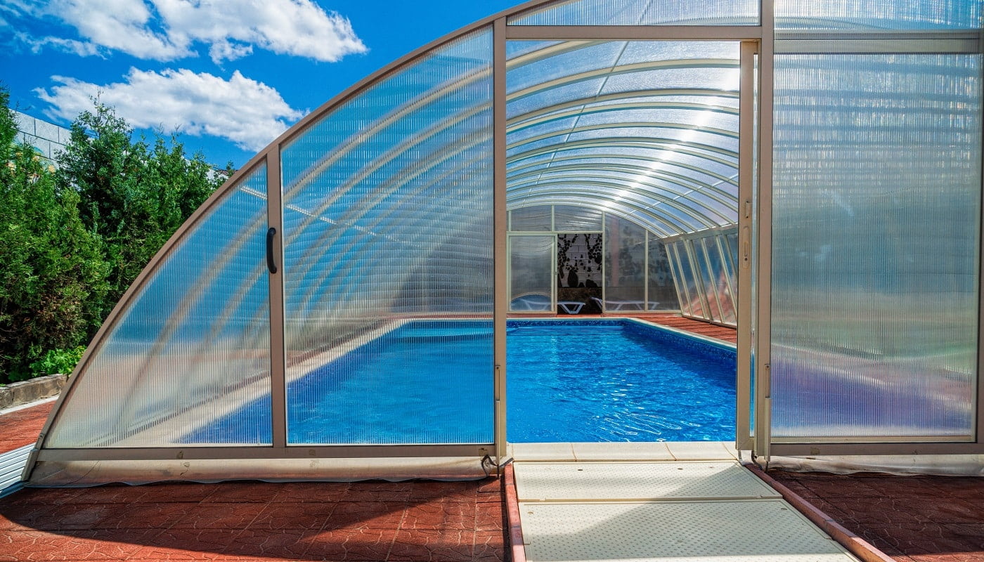 The covered area of the pool water retains heat longer. Also in a canopy you can bring heating. The polycarbonate lid keeps the temperature of the water, but also protects the pond from debris
