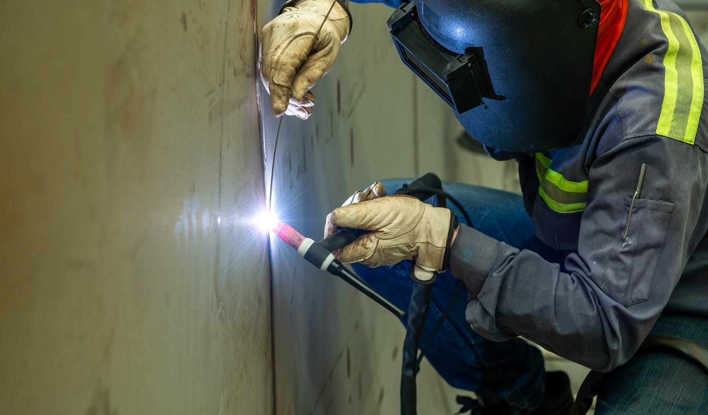 Welder is welding Tungsten Inert Gas welding, TIG welding torch
