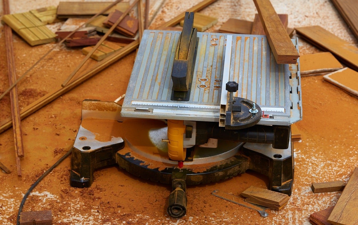 Circular table saw carpenter tool and sawdust in deck installation