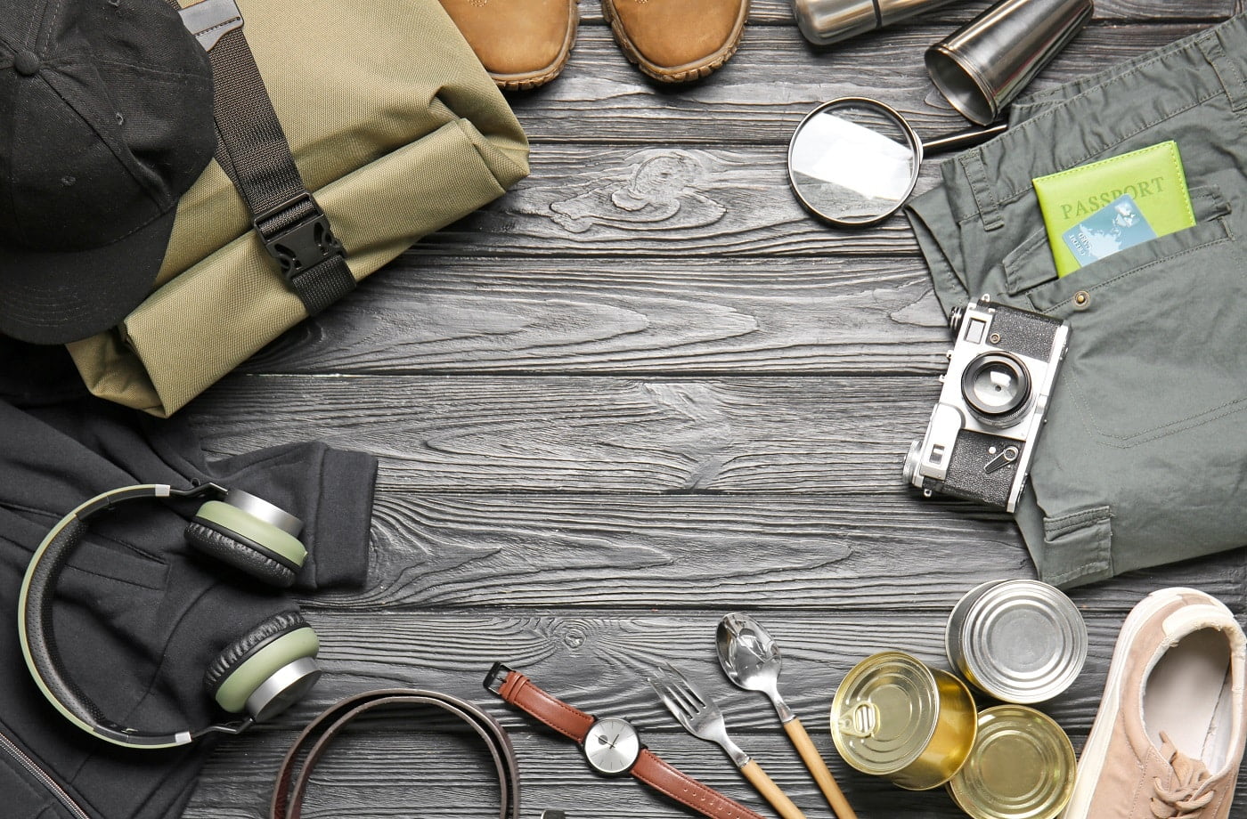 Set of traveler's accessories on wooden background