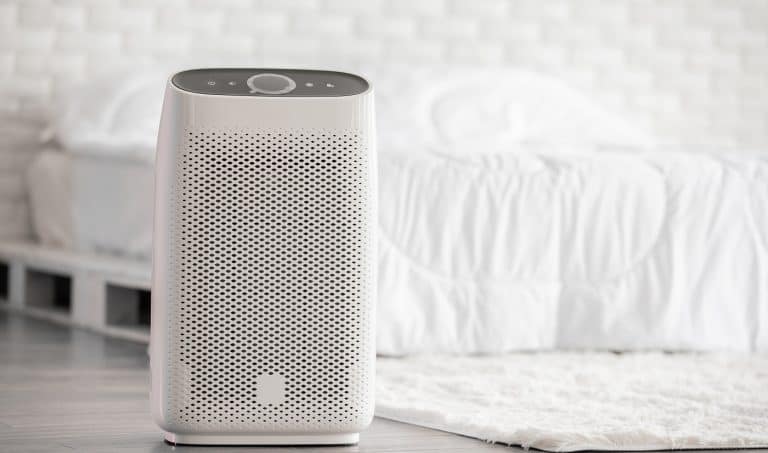 Air purifier in cozy white bed room for filter and cleaning removing dust PM2.5 HEPA in home,for fresh air and healthy life,Air Pollution Concept. AeraMax 300 HEPA Air Purifier Review