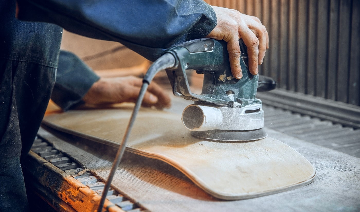 Carpenter using circular saw for cutting wooden boards. Construction details of male worker or handy man with power tools