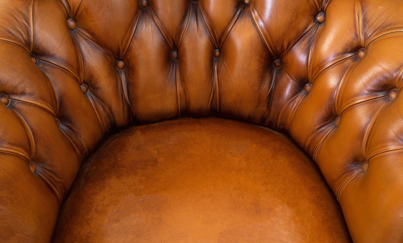 Brown chesterfield Style leather abstract background texture, armchair close up modern design