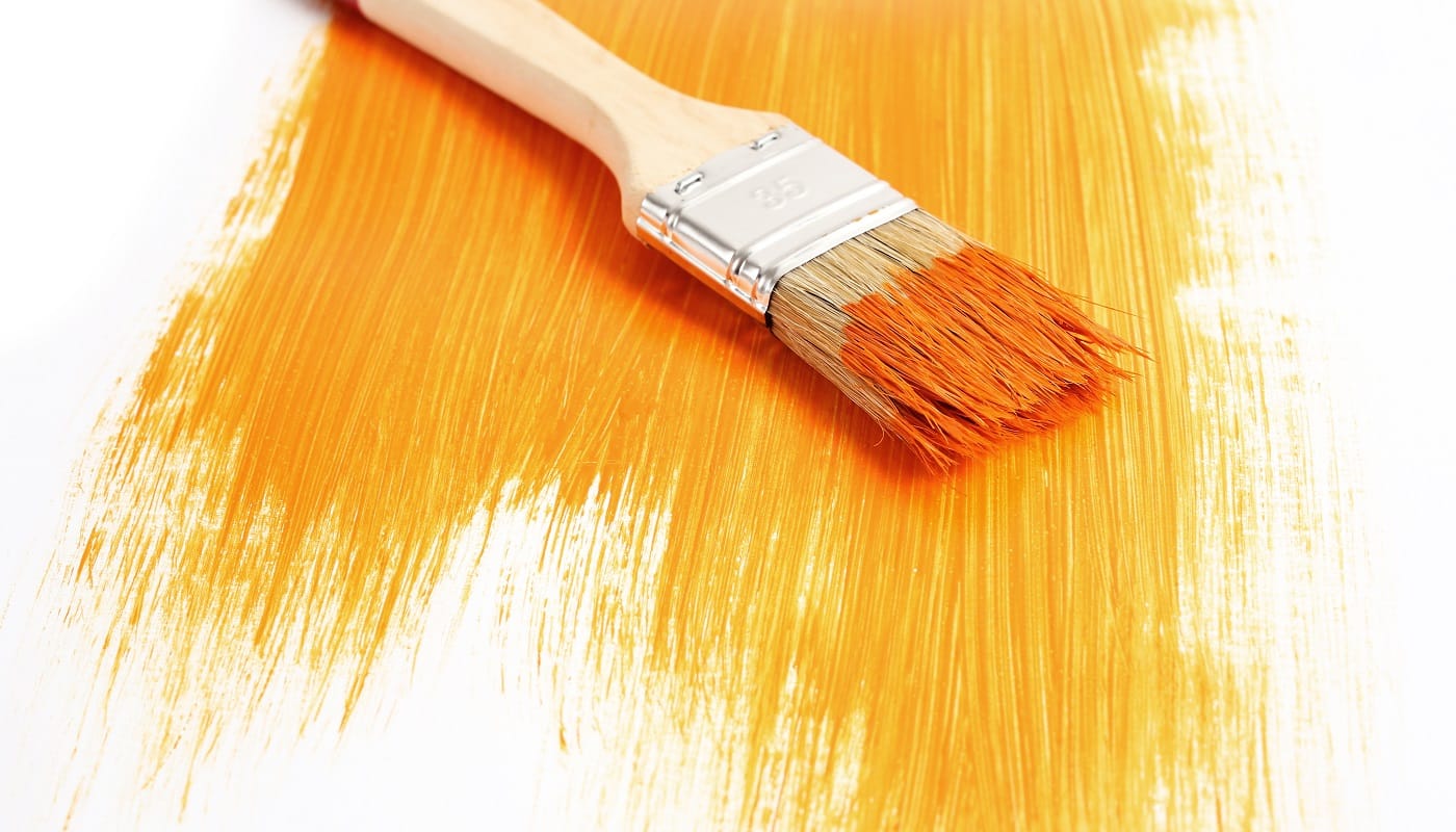 Renovation. Brush with orange paint