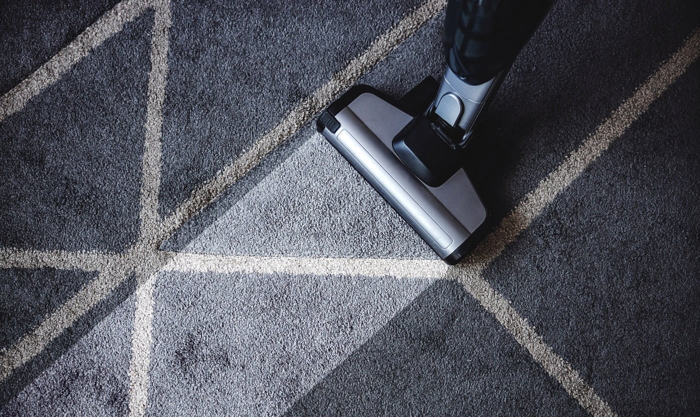 Close up of steam cleaner cleaning very dirty carpet.