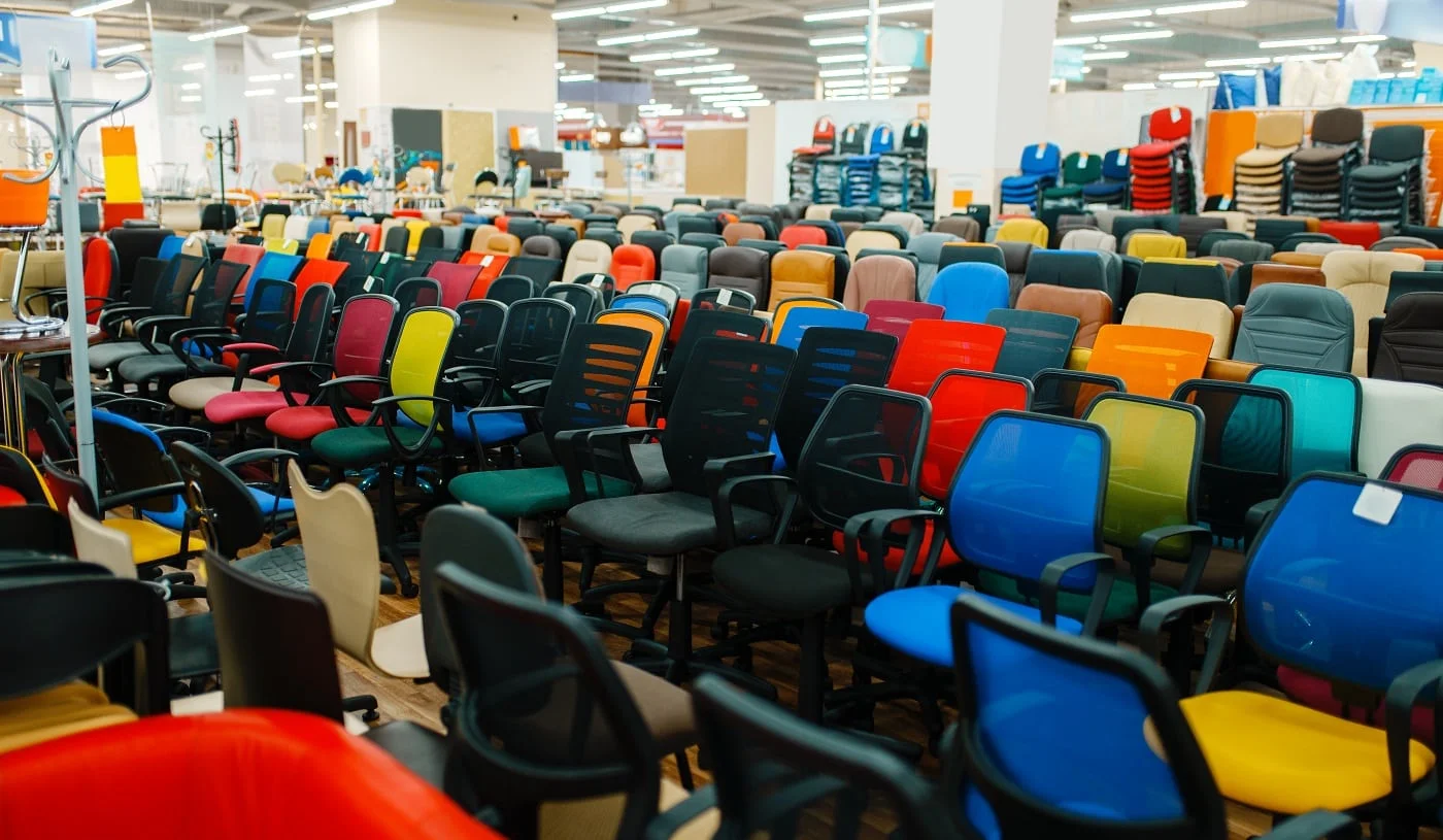 Rows of different office chairs in furniture store showroom, nobody. Comfort seats samples in shop, goods for modern interior