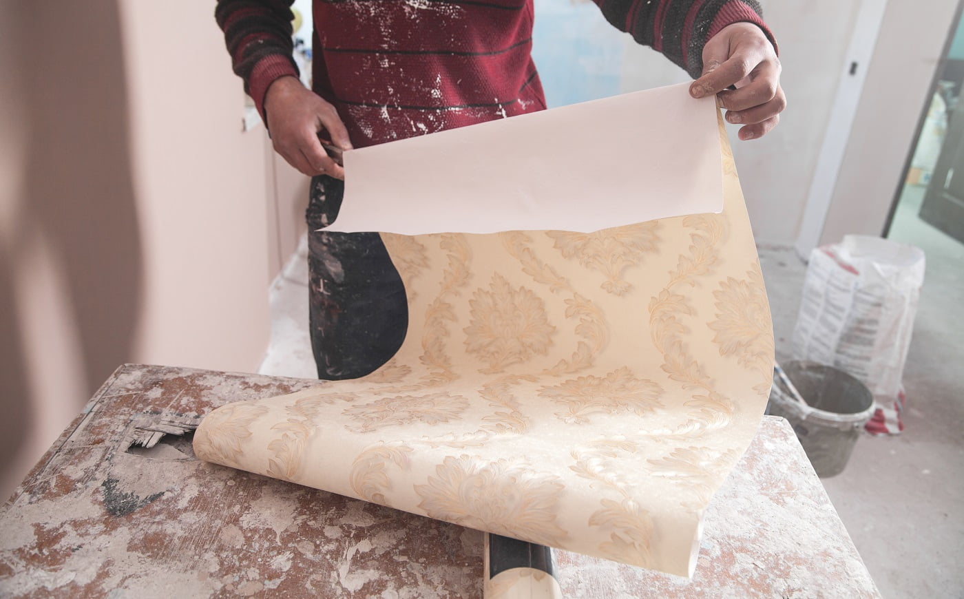 Man holding wallpaper Vinyl Glue Buyers Guide