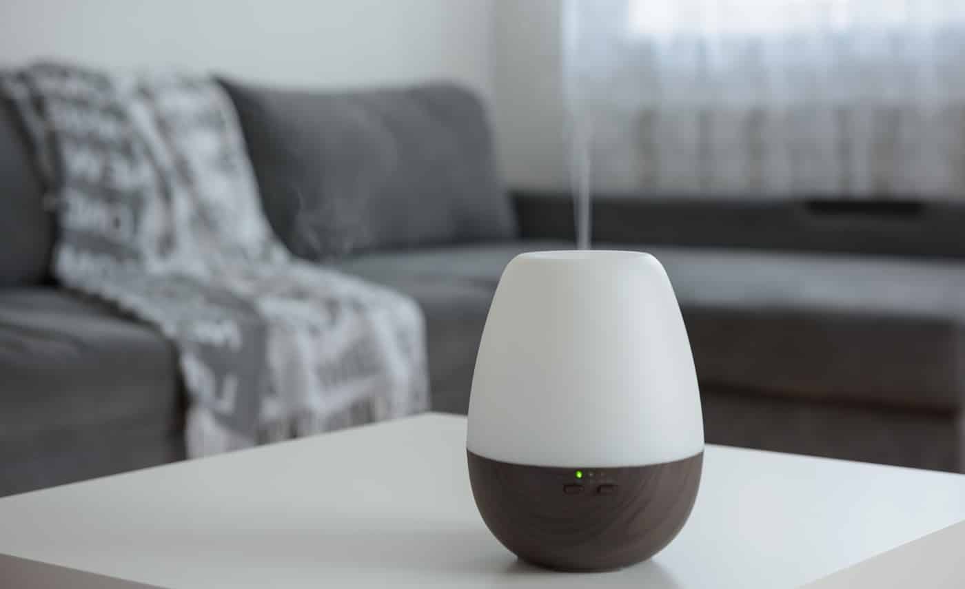 Essential Oil Diffusers on a white table on the background of the interior.