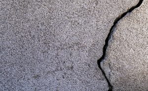 A closeup shot of a crack in a concrete wall. Best Concrete Crack Filler. Concrete Crack Filler Buying Guide