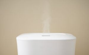 Modern air humidifier on a colored background, closeup.
