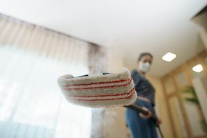 Woman washes the floor with a steam mop. Summing It Up On Bissell