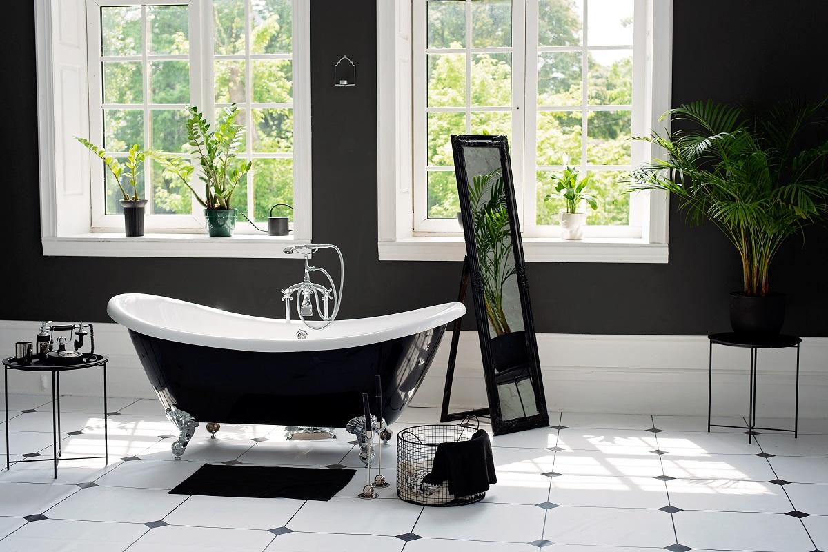Black and white modern bathroom with silver fittings with large sunny windows. Interior design concept. Soft selective focus.