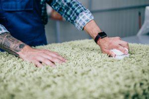 Professional worker doing his job at carpet washing service. How To Get Ink Out Of Carpet