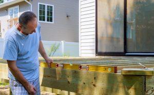 Close up of exterior timber decking building a backyard deck with composite deck boards