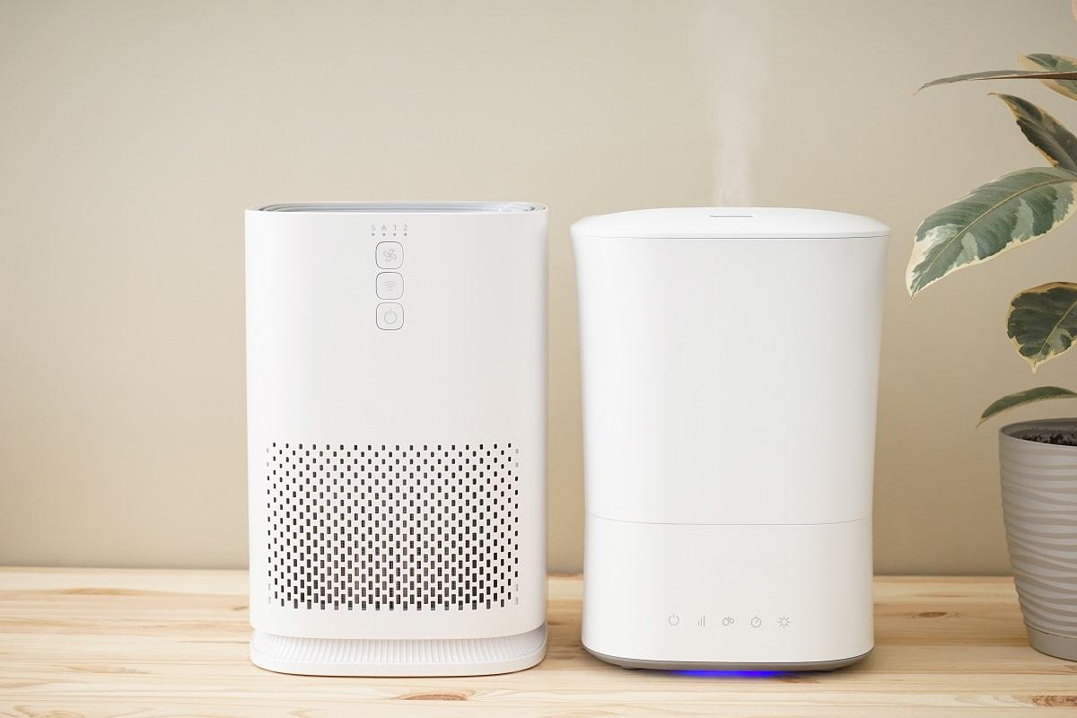 Modern humidifier and air purifier on a colored background.