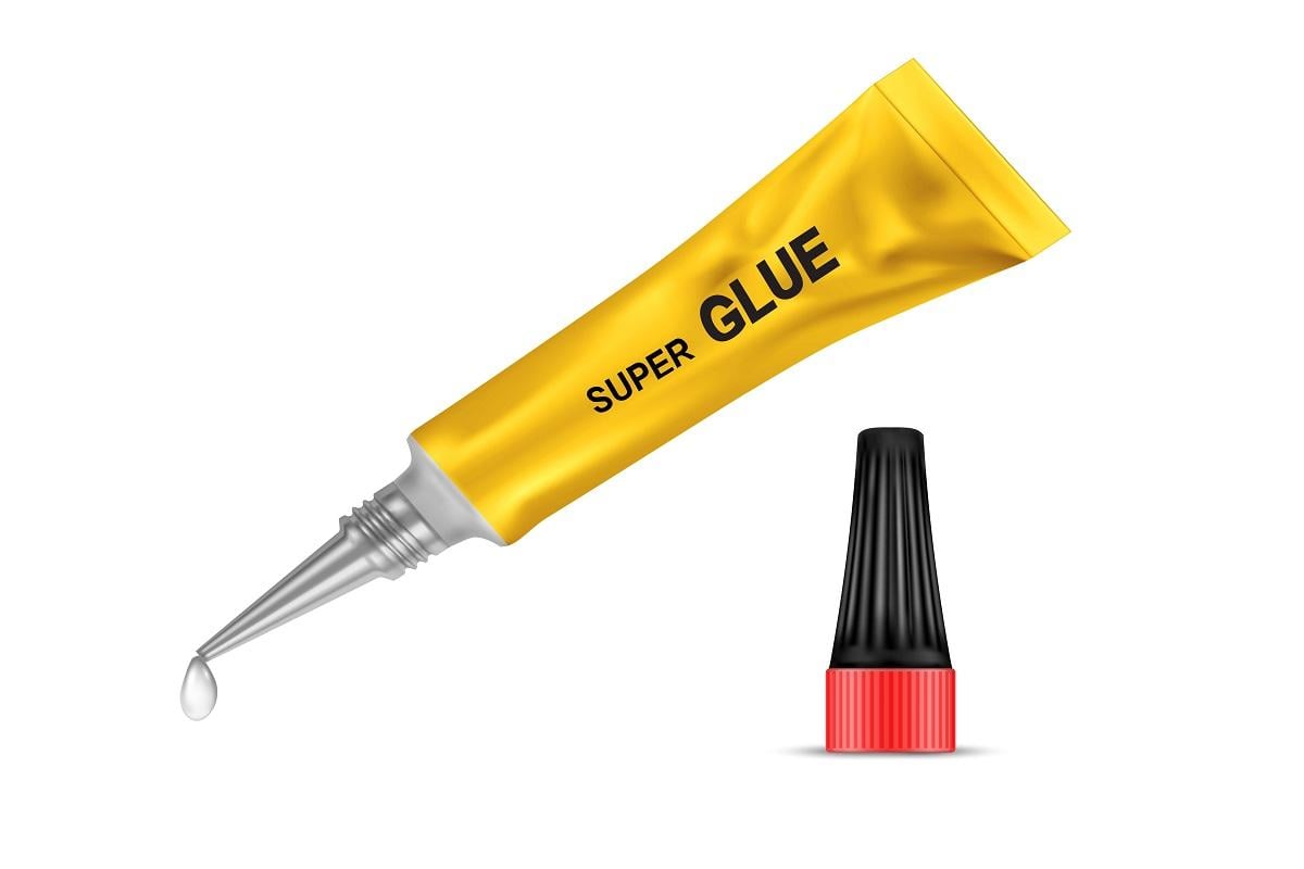 Vector realistic yellow metal tube of super glue, with open black lid and with liquid drop at a tip, isolated on background. Container with adhesive for any purpose. Mockup for package design