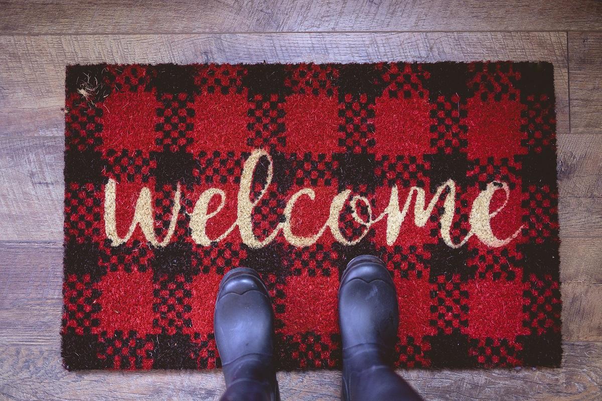 An overhead shot of a person standing on a welcome mat