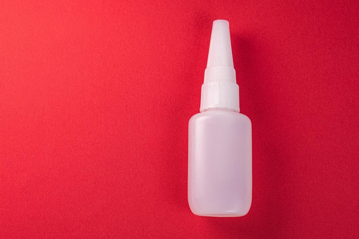Glue bottle on the colorful background