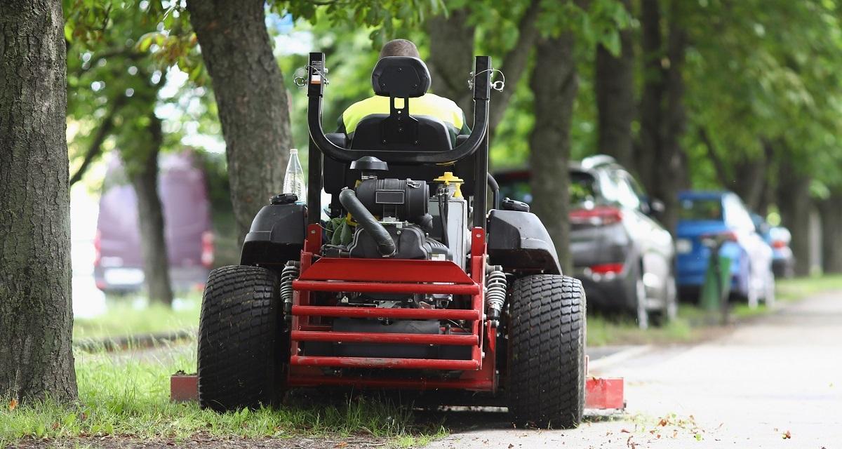 Best Zero Turn Mowers For 5 Acres on the city sidewalk near the lawn 