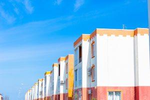 Modern high-rise residential building in the Spanish style against the blue sky.