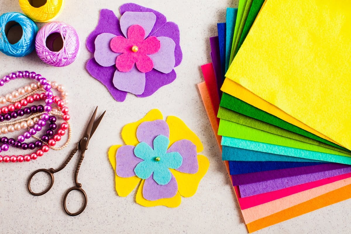 Top view of felt decorations, scissors and beads - kids DIY crafts tutorial