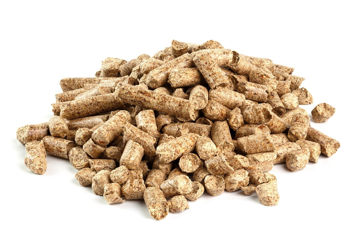 Small pile of pressed wooden dry sawdust pellets isolated on white background. Biofuel and pet litter, mulch.