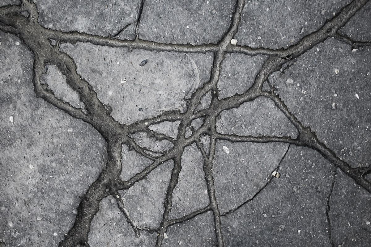 asphalt in cracks texture / abstract background cracks on asphalt road. Top Asphalt Crack Filler Verdict.