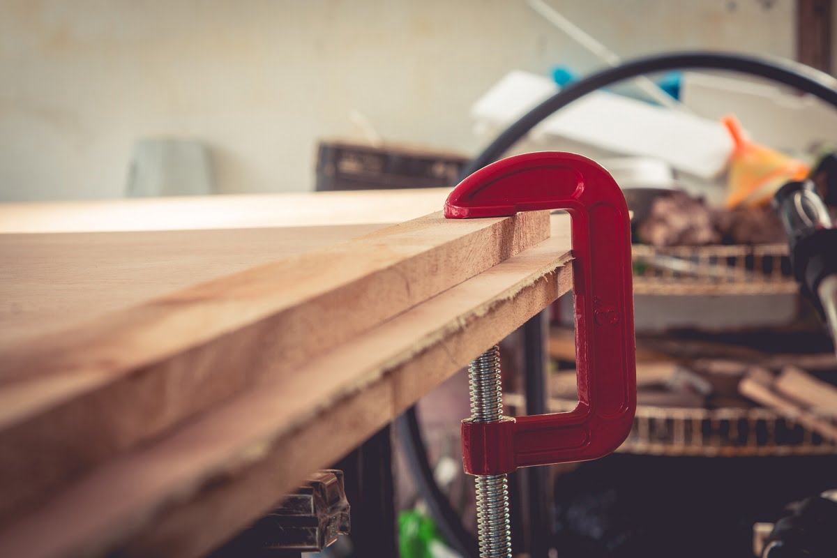 Joiner fastens clamps on a wooden surface for better gluing. Can You Use Super Glue On Wood.