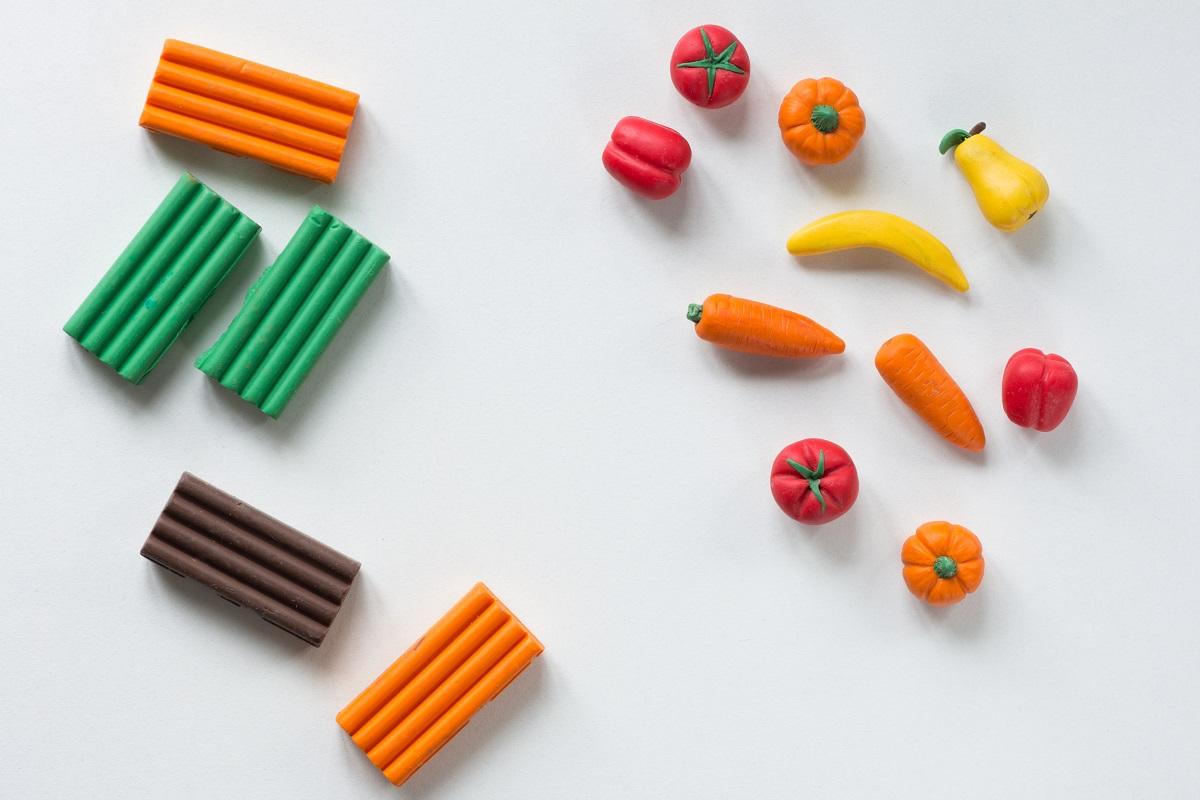 Pieces of polymer clay and handmade fruits and vegetables from it on the white background. Air Drying Clay Vs Polymer Clay Final Words.