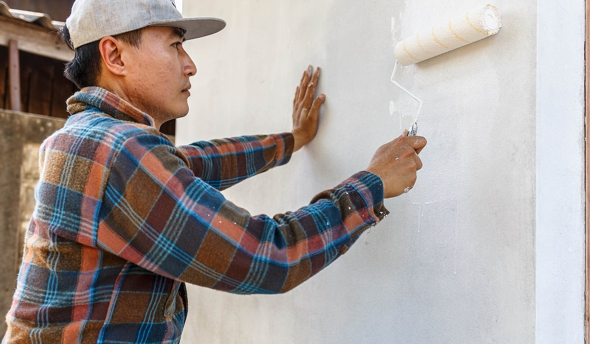 Painter works to paint white bathroom walls. Special Paint For Bathrooms Final Words.