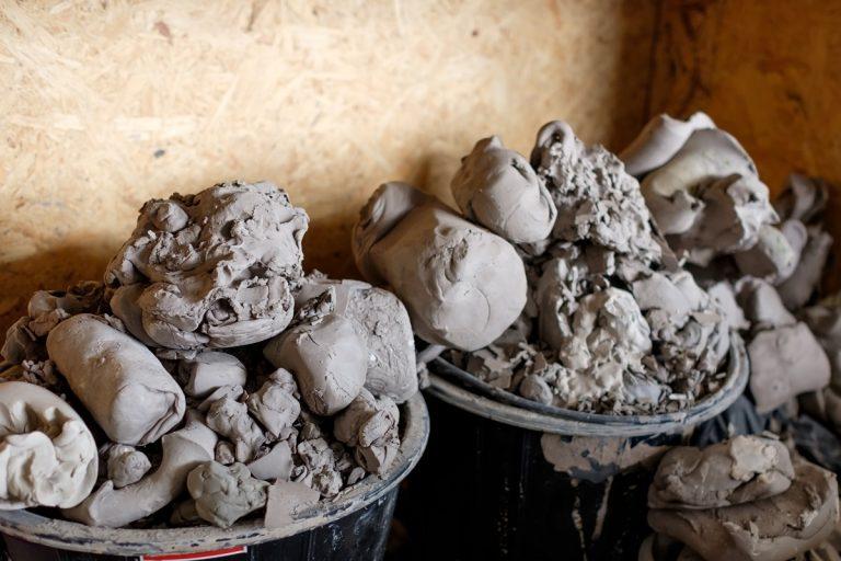 A lot of pieces of gray clay for modeling in basket. Create new ceramics. How To Store Clay.
