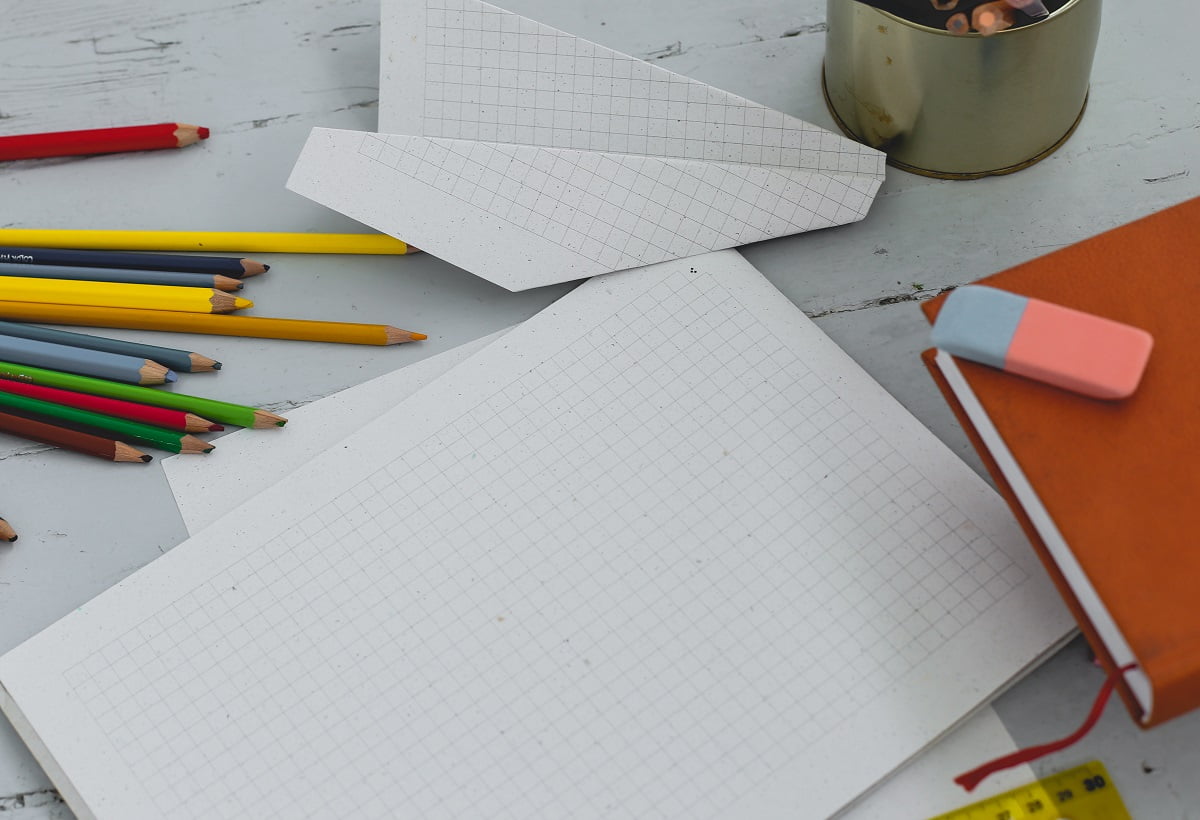 School, education. Book with pencils on the table. How To Erase Using A Colored Pencil Eraser.