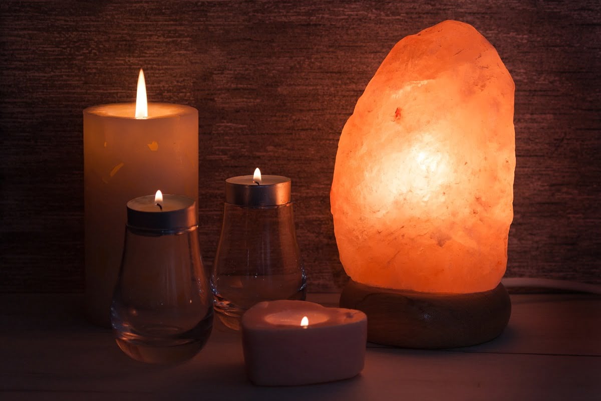 Himalayan salt lamp with, candles in dark room. Spa, relax concept. Best Himalayan Salt Lamps.